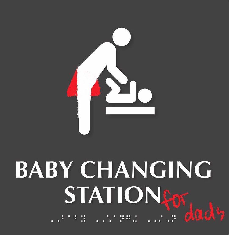 "BABY CHANGING STATION" sign with person changing a baby's diaper. Red skirt has been pushed into the background, making it less important. "for dads" added at the end of the text.